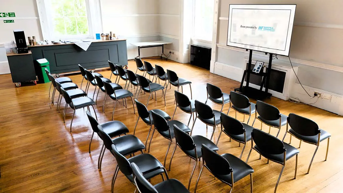 Set out theatre style: rows of chairs facing the big screen.